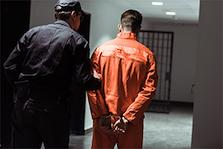 Police officer holding a prisioner in jail